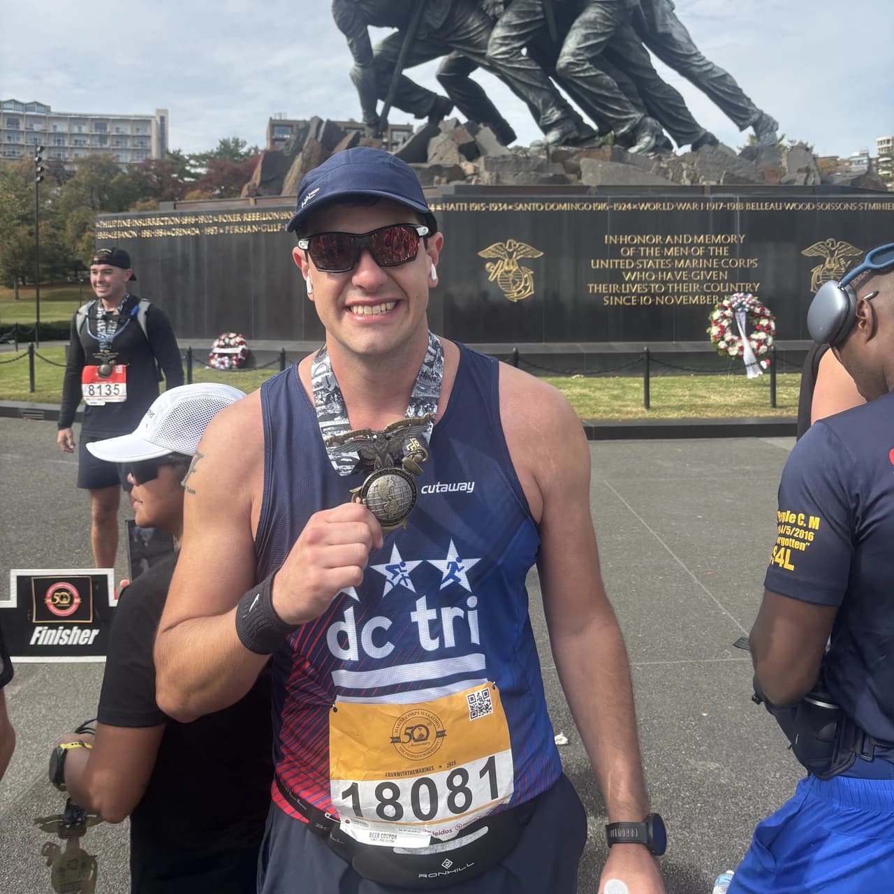 francisco sandi crossing the finish line of the marine corps marathon, 2025